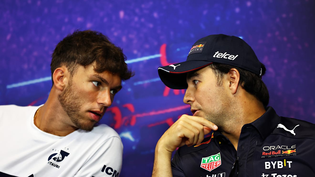LE CASTELLET, FRANCE - JULY 21: Pierre Gasly of France and Scuderia AlphaTauri and Sergio Perez of Mexico and Oracle Red Bull Racing talk in the Drivers Press Conference during previews ahead of the F1 Grand Prix of France at Circuit Paul Ricard on July 21, 2022 in Le Castellet, France. (Photo by Bryn Lennon/Getty Images)