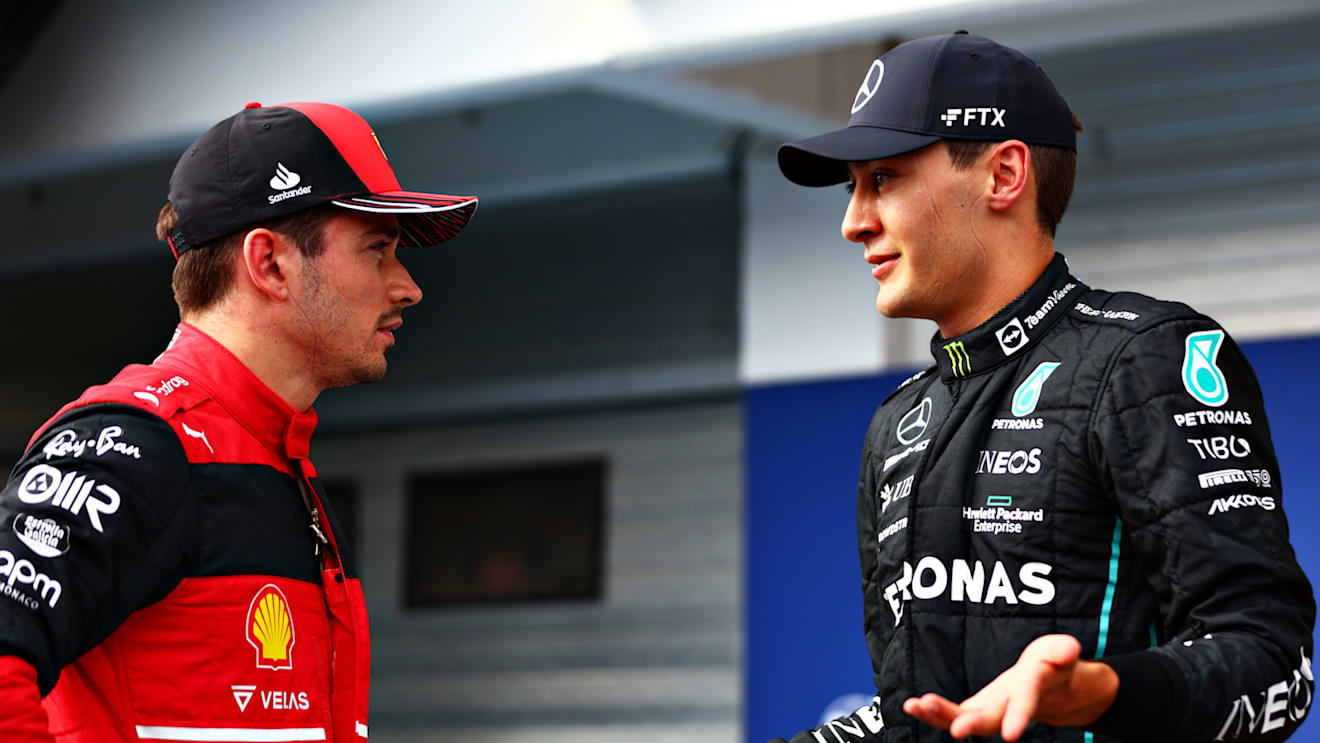 BUDAPEST, HUNGARY - JULY 30: Pole position qualifier George Russell of Great Britain and Mercedes talks with Third placed qualifier Charles Leclerc of Monaco and Ferrari in parc ferme during qualifying ahead of the F1 Grand Prix of Hungary at Hungaroring on July 30, 2022 in Budapest, Hungary. (Photo by Dan Istitene - Formula 1/Formula 1 via Getty Images)
