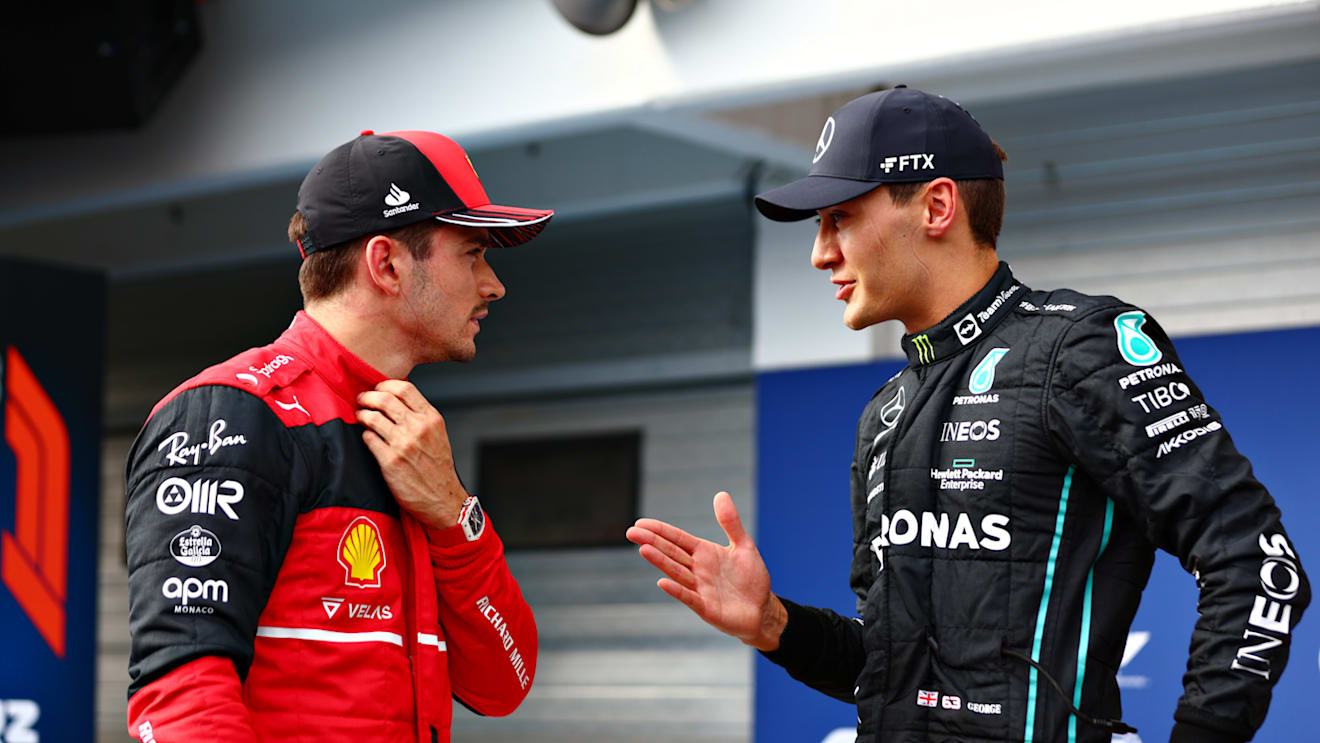 BUDAPEST, HUNGARY - JULY 30: Pole position qualifier George Russell of Great Britain and Mercedes talks with Third placed qualifier Charles Leclerc of Monaco and Ferrari in parc ferme during qualifying ahead of the F1 Grand Prix of Hungary at Hungaroring on July 30, 2022 in Budapest, Hungary. (Photo by Dan Istitene - Formula 1/Formula 1 via Getty Images)