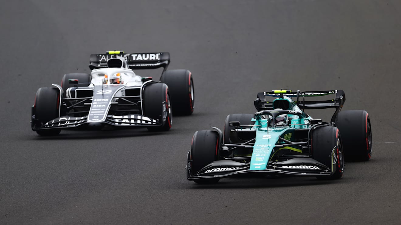 BUDAPEST, HUNGARY - JULY 31: Sebastian Vettel of Germany driving the (5) Aston Martin AMR22 Mercedes leads Yuki Tsunoda of Japan driving the (22) Scuderia AlphaTauri AT03 during the F1 Grand Prix of Hungary at Hungaroring on July 31, 2022 in Budapest, Hungary. (Photo by Dan Istitene - Formula 1/Formula 1 via Getty Images)