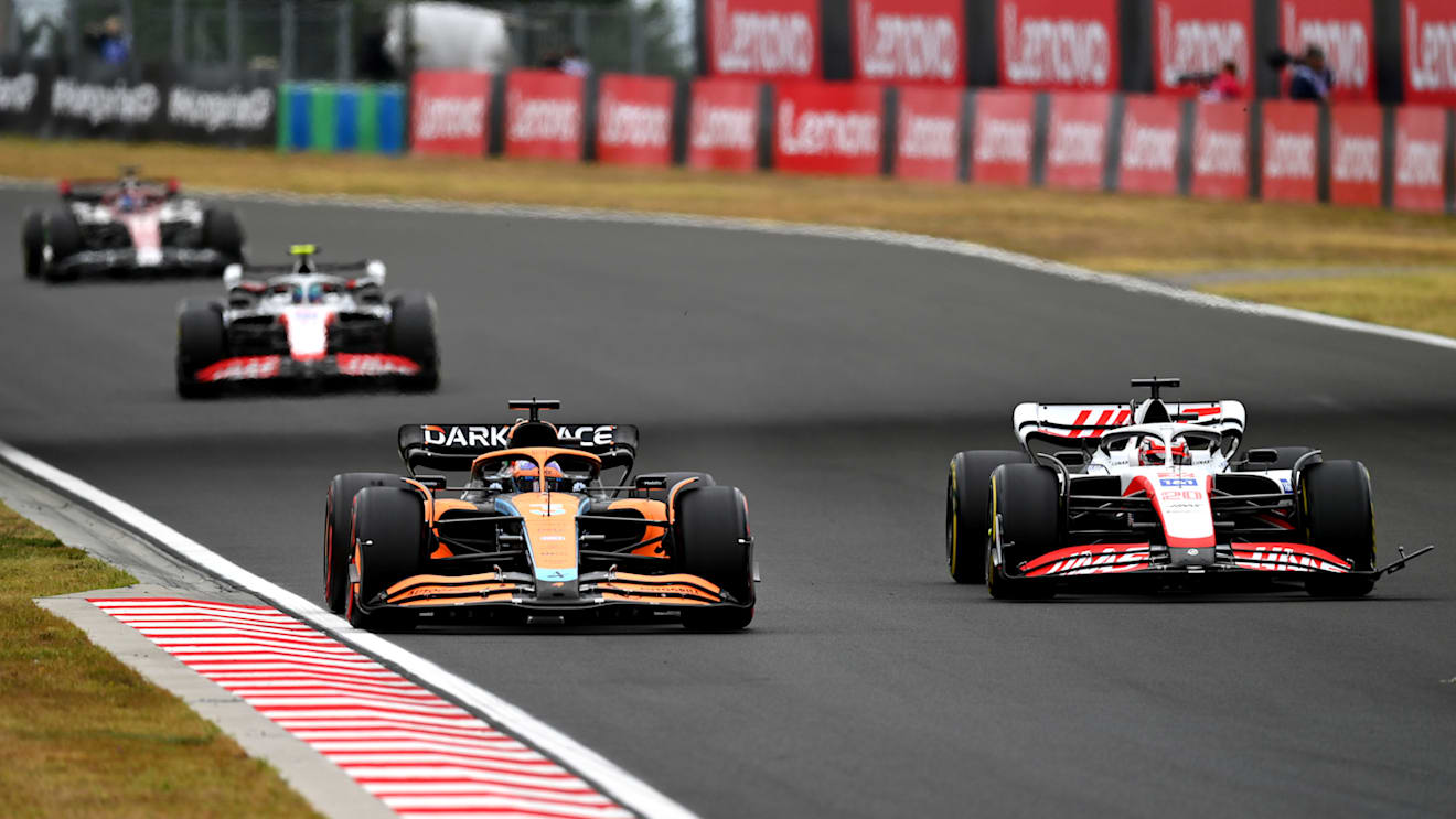 BUDAPEST, HUNGARY - JULY 31: Daniel Ricciardo of Australia driving the (3) McLaren MCL36 Mercedes and Kevin Magnussen of Denmark driving the (20) Haas F1 VF-22 Ferrari battle for track position during the F1 Grand Prix of Hungary at Hungaroring on July 31, 2022 in Budapest, Hungary. (Photo by Dan Mullan/Getty Images)