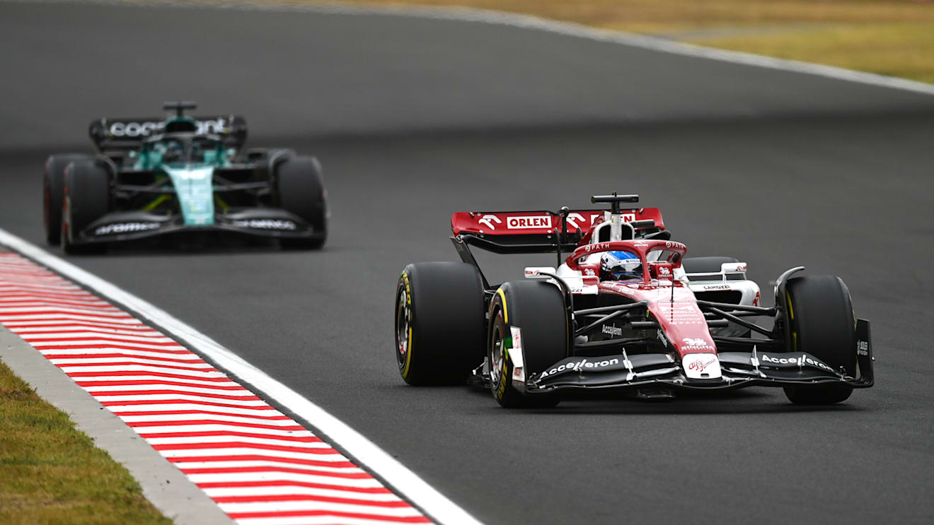 BUDAPEST, HUNGARY - JULY 31: Valtteri Bottas of Finland driving the (77) Alfa Romeo F1 C42 Ferrari leads Lance Stroll of Canada driving the (18) Aston Martin AMR22 Mercedes during the F1 Grand Prix of Hungary at Hungaroring on July 31, 2022 in Budapest, Hungary. (Photo by Dan Mullan/Getty Images)