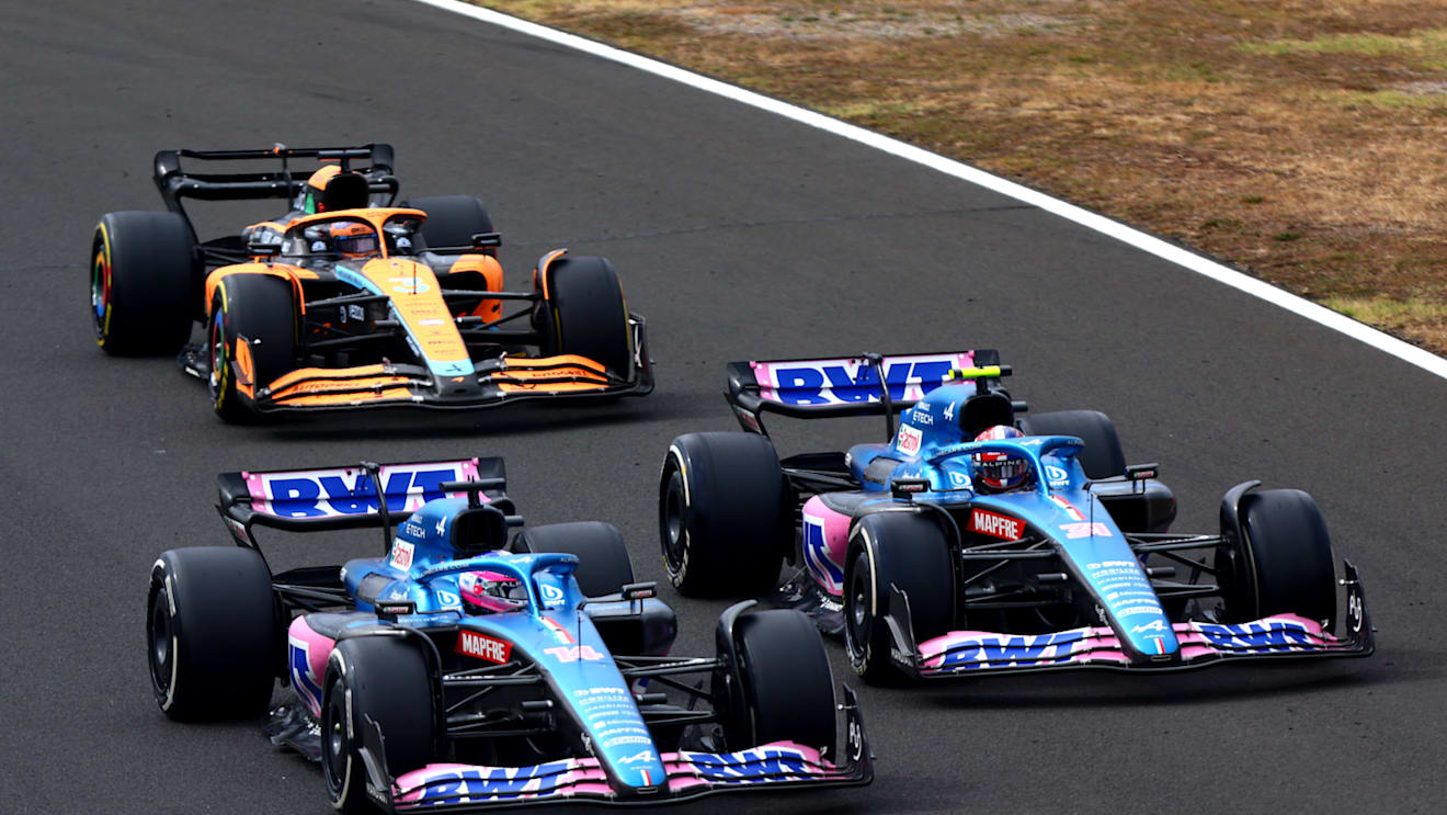BUDAPEST, HUNGARY - JULY 31: Fernando Alonso of Spain driving the (14) Alpine F1 A522 Renault, Esteban Ocon of France driving the (31) Alpine F1 A522 Renault and Daniel Ricciardo of Australia driving the (3) McLaren MCL36 Mercedes battle for track position during the F1 Grand Prix of Hungary at Hungaroring on July 31, 2022 in Budapest, Hungary. (Photo by Dan Istitene - Formula 1/Formula 1 via Getty Images)