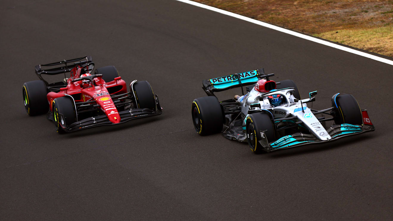 BUDAPEST, HUNGARY - JULY 31: George Russell of Great Britain driving the (63) Mercedes AMG Petronas F1 Team W13 leads Charles Leclerc of Monaco driving the (16) Ferrari F1-75 during the F1 Grand Prix of Hungary at Hungaroring on July 31, 2022 in Budapest, Hungary. (Photo by Dan Istitene - Formula 1/Formula 1 via Getty Images)