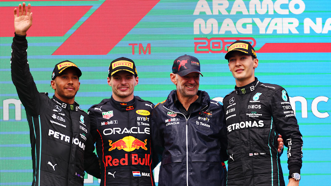 BUDAPEST, HUNGARY - JULY 31: Race winner Max Verstappen of the Netherlands and Oracle Red Bull Racing (second from left), Second placed Lewis Hamilton of Great Britain and Mercedes (L), Third placed George Russell of Great Britain and Mercedes (R) and Adrian Newey, the Chief Technical Officer of Red Bull Racing (second from right) celebrate on the podium during the F1 Grand Prix of Hungary at Hungaroring on July 31, 2022 in Budapest, Hungary. (Photo by Bryn Lennon - Formula 1/Formula 1 via Getty Images)