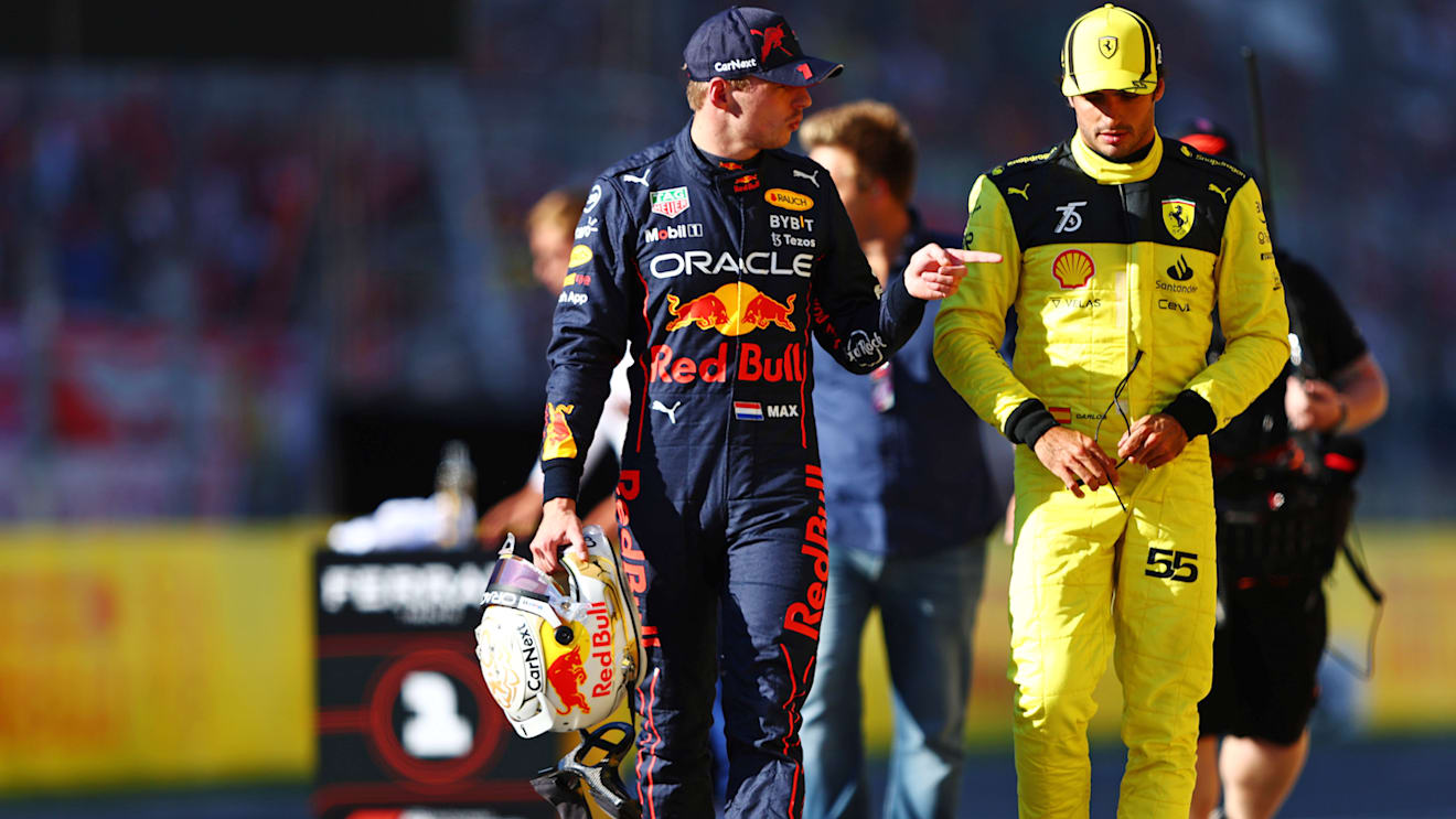 MONZA, ITALY - SEPTEMBER 10: Second placed qualifier Max Verstappen of the Netherlands and Oracle Red Bull Racing and Third placed qualifier Carlos Sainz of Spain and Ferrari talk in parc ferme during qualifying ahead of the F1 Grand Prix of Italy at Autodromo Nazionale Monza on September 10, 2022 in Monza, Italy. (Photo by Mark Thompson/Getty Images)