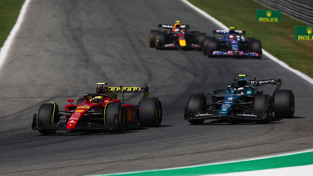 MONZA, ITALY - SEPTEMBER 11: Carlos Sainz of Spain driving (55) the Ferrari F1-75 leads Sebastian Vettel of Germany driving the (5) Aston Martin AMR22 Mercedes during the F1 Grand Prix of Italy at Autodromo Nazionale Monza on September 11, 2022 in Monza, Italy. (Photo by Alex Pantling - Formula 1/Formula 1 via Getty Images)