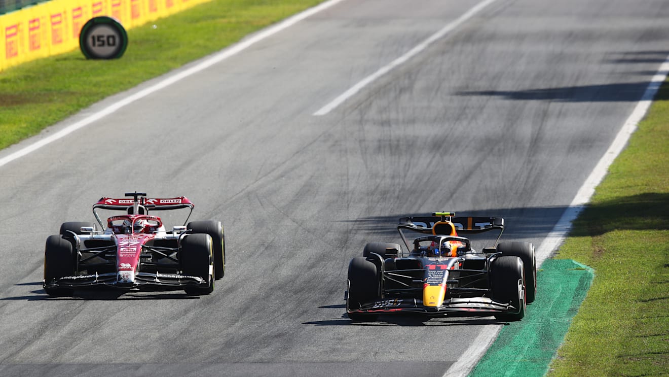 MONZA, ITALY - SEPTEMBER 11: Sergio Perez of Mexico driving the (11) Oracle Red Bull Racing RB18 and Valtteri Bottas of Finland driving the (77) Alfa Romeo F1 C42 Ferrari battle for track position during the F1 Grand Prix of Italy at Autodromo Nazionale Monza on September 11, 2022 in Monza, Italy. (Photo by Joe Portlock - Formula 1/Formula 1 via Getty Images)