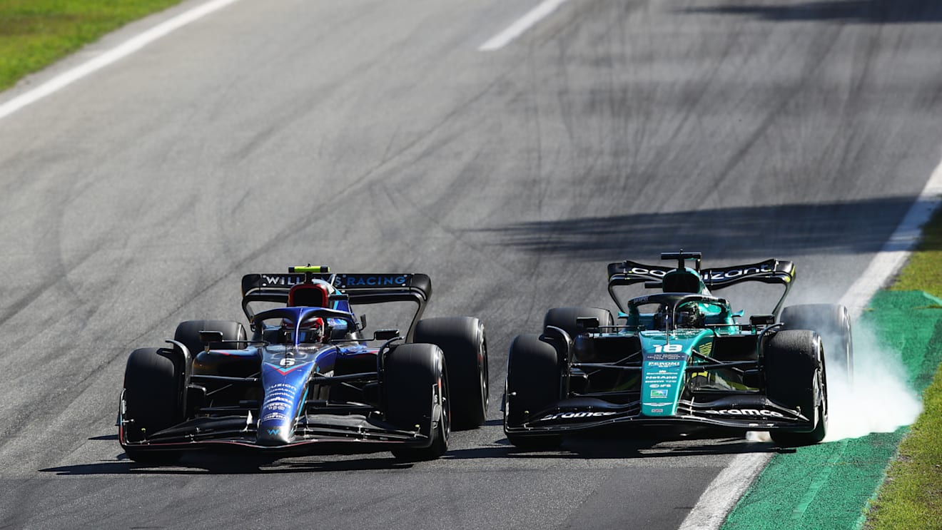 MONZA, ITALY - SEPTEMBER 11: Lance Stroll of Canada driving the (18) Aston Martin AMR22 Mercedes locks a wheel under braking as he battles for track position with Nicholas Latifi of Canada driving the (6) Williams FW44 Mercedes  during the F1 Grand Prix of Italy at Autodromo Nazionale Monza on September 11, 2022 in Monza, Italy. (Photo by Joe Portlock - Formula 1/Formula 1 via Getty Images)