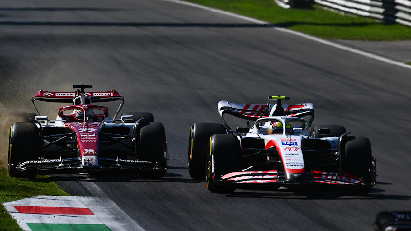 MONZA, ITALY - SEPTEMBER 11: Valtteri Bottas of Finland driving the (77) Alfa Romeo F1 C42 Ferrari runs wide as he and Mick Schumacher of Germany and Haas F1 battle for track position during the F1 Grand Prix of Italy at Autodromo Nazionale Monza on September 11, 2022 in Monza, Italy. (Photo by Clive Mason/Getty Images)