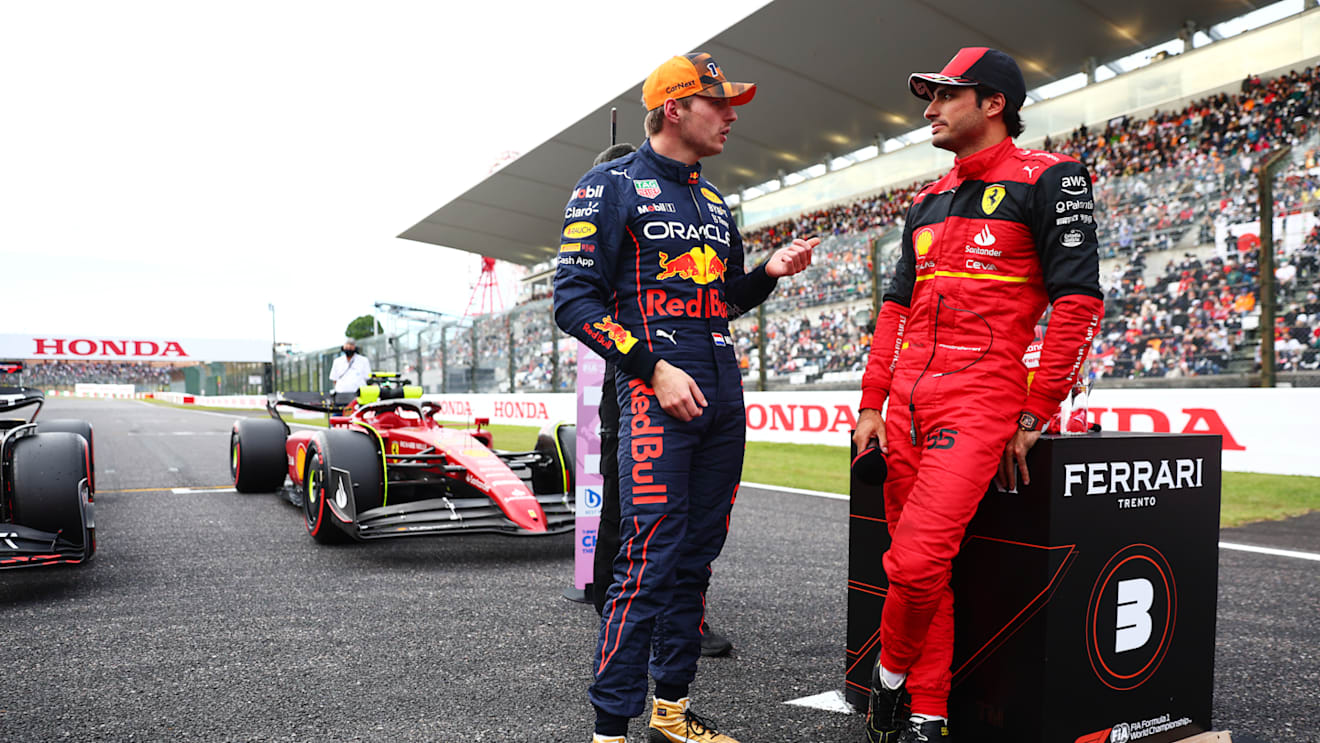 SUZUKA, JAPAN - OCTOBER 08: Pole position qualifier Max Verstappen of the Netherlands and Oracle Red Bull Racing and Third placed qualifier Carlos Sainz of Spain and Ferrari talk in parc ferme during qualifying ahead of the F1 Grand Prix of Japan at Suzuka International Racing Course on October 08, 2022 in Suzuka, Japan. (Photo by Dan Istitene - Formula 1/Formula 1 via Getty Images)