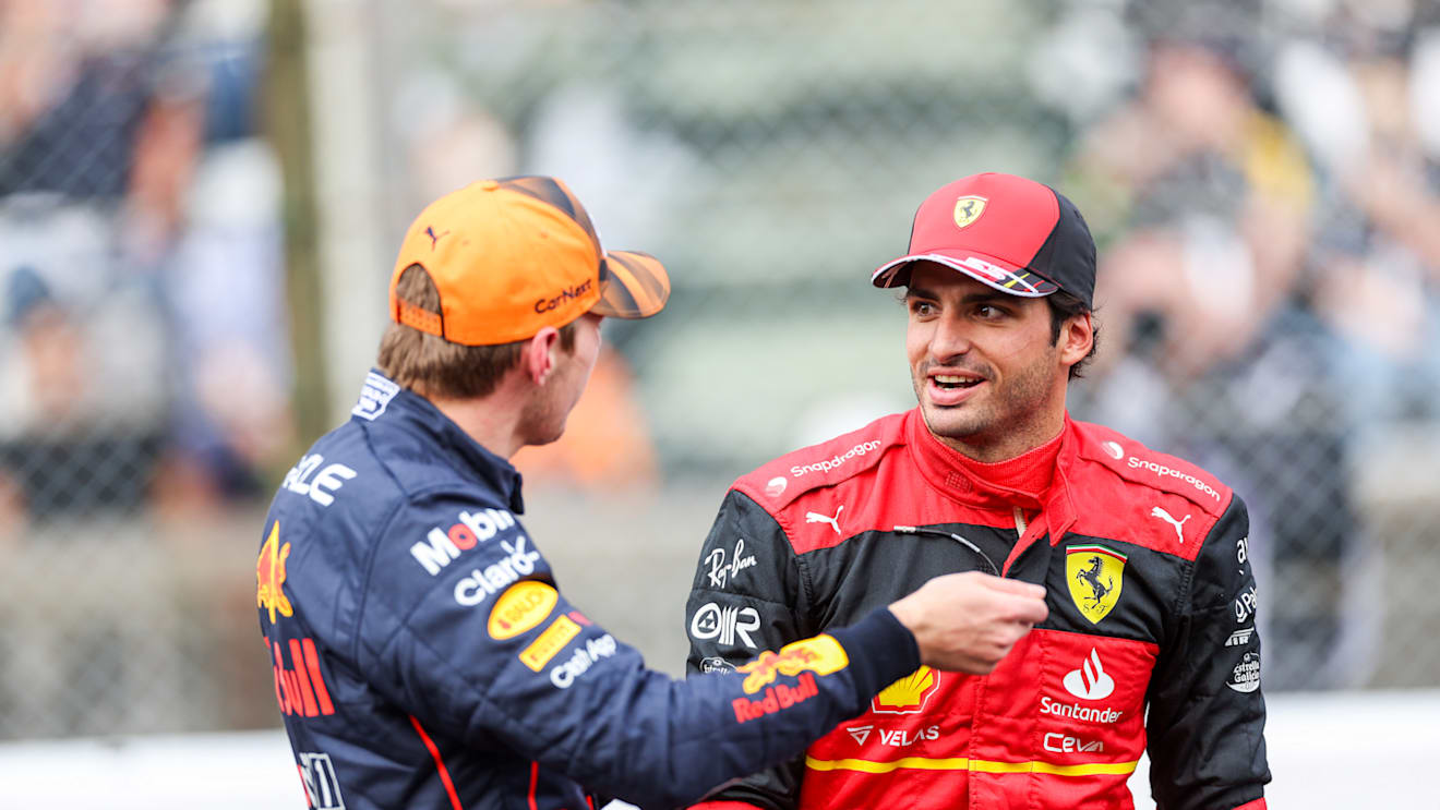 SUZUKA, JAPAN - OCTOBER 08: Max Verstappen of Red Bull Racing and The Netherlands hats with Carlos Sainz of Ferrari and Spain  during qualifying ahead of the F1 Grand Prix of Japan at Suzuka International Racing Course on October 08, 2022 in Suzuka, Japan. (Photo by Peter Fox/Getty Images )