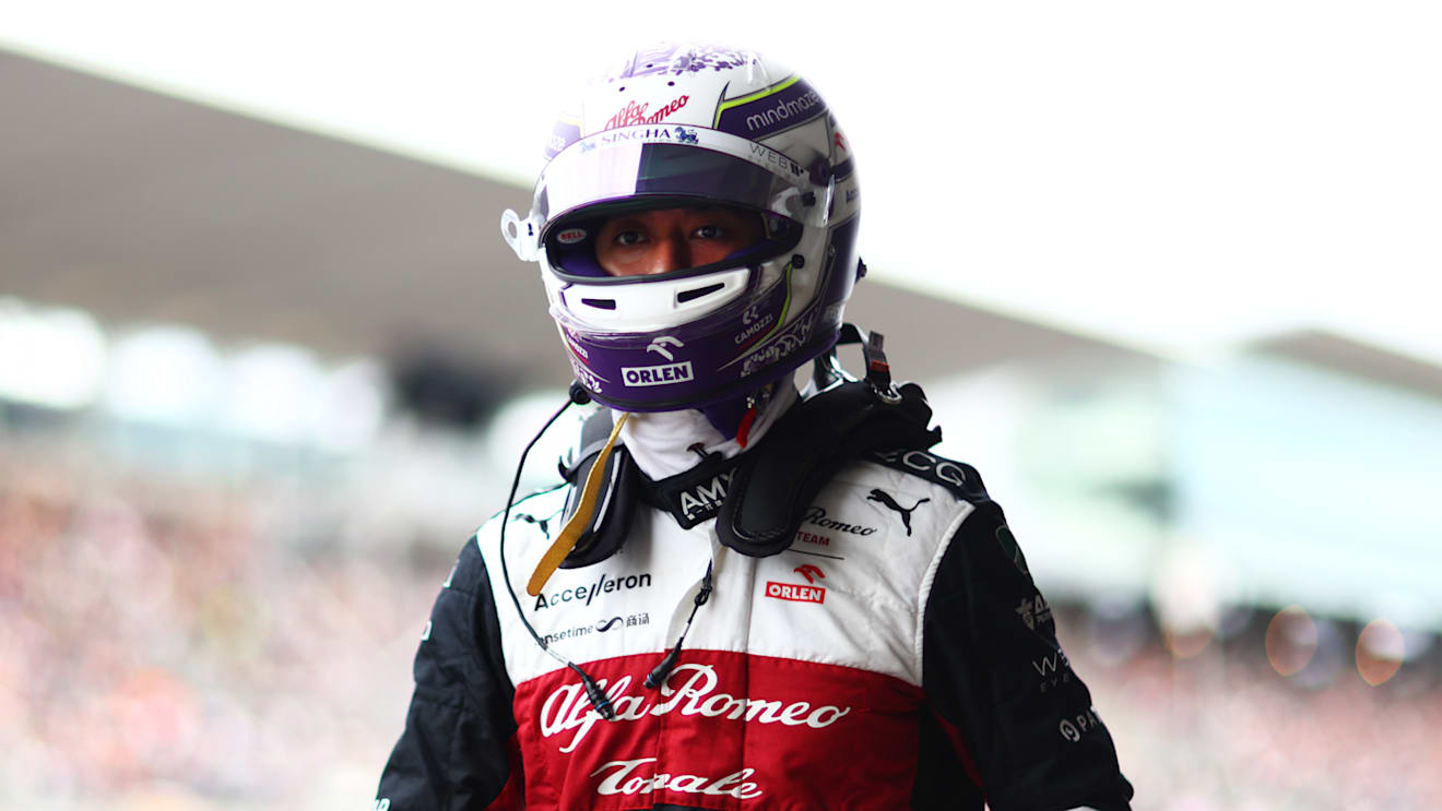 SUZUKA, JAPAN - OCTOBER 08: Fourteenth placed qualifier Zhou Guanyu of China and Alfa Romeo F1 walks in the Pitlane during qualifying ahead of the F1 Grand Prix of Japan at Suzuka International Racing Course on October 08, 2022 in Suzuka, Japan. (Photo by Dan Istitene - Formula 1/Formula 1 via Getty Images)