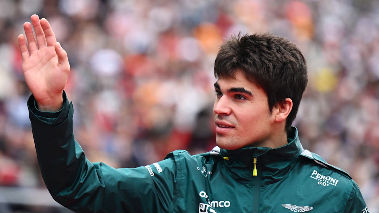 SUZUKA, JAPAN - OCTOBER 09: Lance Stroll of Canada and Aston Martin F1 Team waves to the crowd during the drivers parade ahead of the F1 Grand Prix of Japan at Suzuka International Racing Course on October 09, 2022 in Suzuka, Japan. (Photo by Clive Mason/Getty Images)