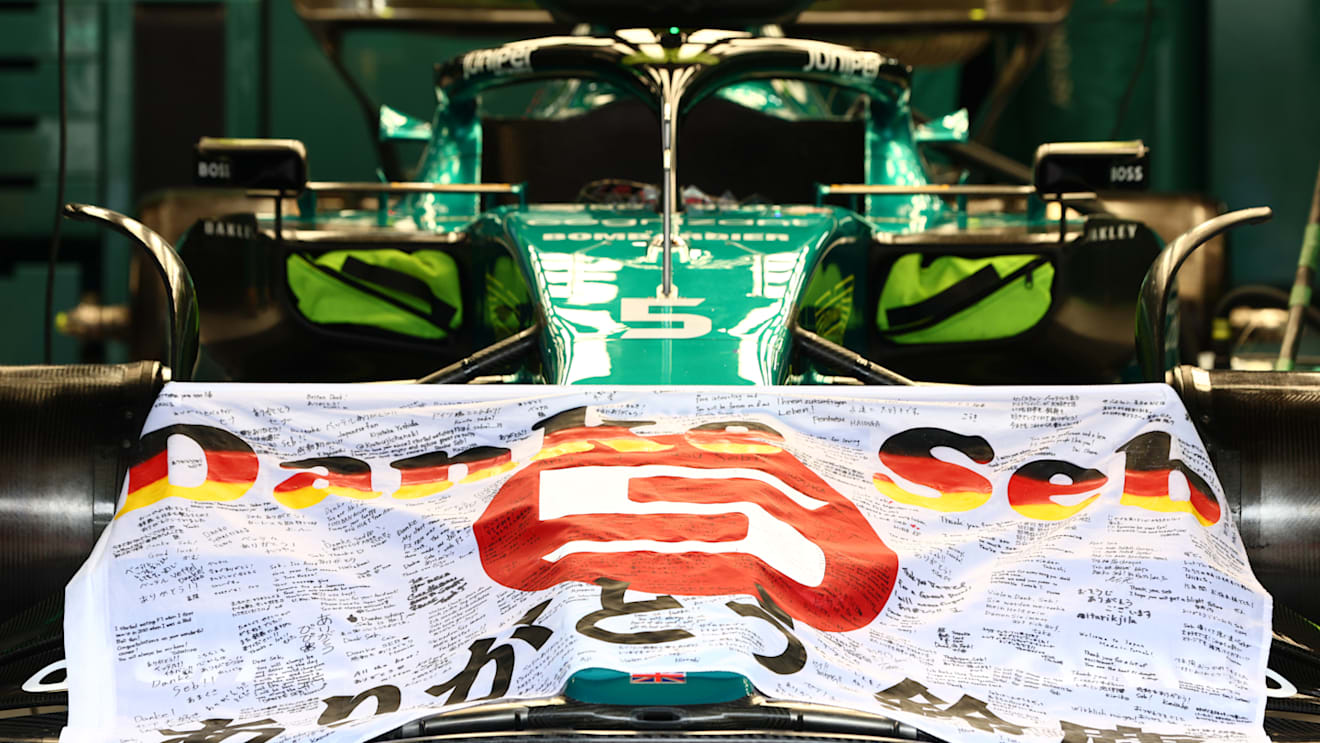 SUZUKA, JAPAN - OCTOBER 09: The car of Sebastian Vettel of Germany and Aston Martin F1 Team is pictured in the garage with a Japan flag thanking him for his F1 career prior to the F1 Grand Prix of Japan at Suzuka International Racing Course on October 09, 2022 in Suzuka, Japan. (Photo by Clive Rose/Getty Images)
