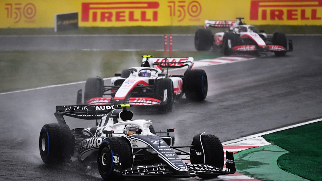 SUZUKA, JAPAN - OCTOBER 09: Yuki Tsunoda of Japan driving the (22) Scuderia AlphaTauri AT03 leads Mick Schumacher of Germany driving the (47) Haas F1 VF-22 Ferrari during the F1 Grand Prix of Japan at Suzuka International Racing Course on October 09, 2022 in Suzuka, Japan. (Photo by Clive Mason/Getty Images)