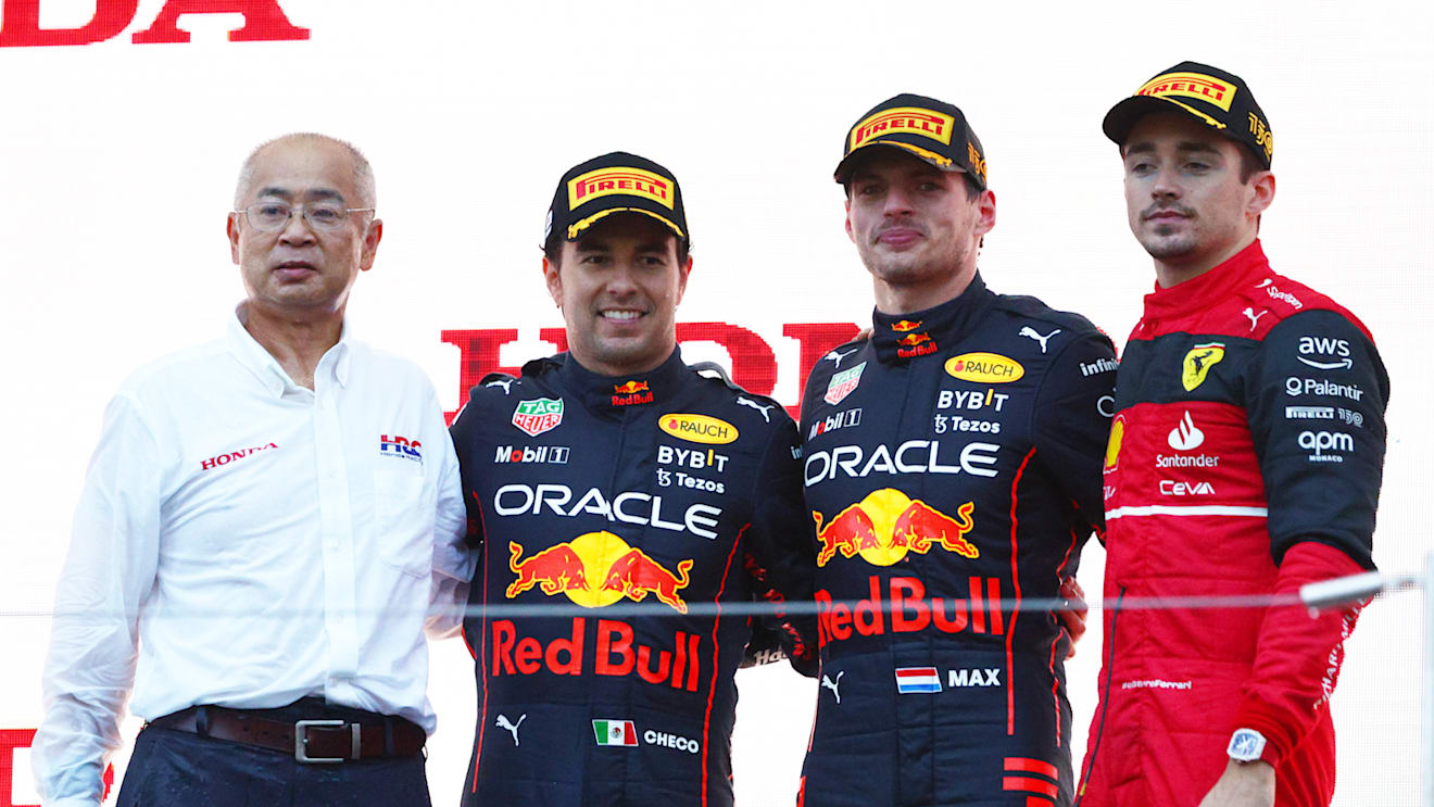 SUZUKA, JAPAN - OCTOBER 09: Race winner and 2022 F1 World Drivers Champion Max Verstappen of Netherlands and Oracle Red Bull Racing (second from right), Second placed Sergio Perez of Mexico and Oracle Red Bull Racing (second from left) and Third placed Charles Leclerc of Monaco and Ferrari celebrate on the podium during the F1 Grand Prix of Japan at Suzuka International Racing Course on October 09, 2022 in Suzuka, Japan. (Photo by Clive Rose/Getty Images)