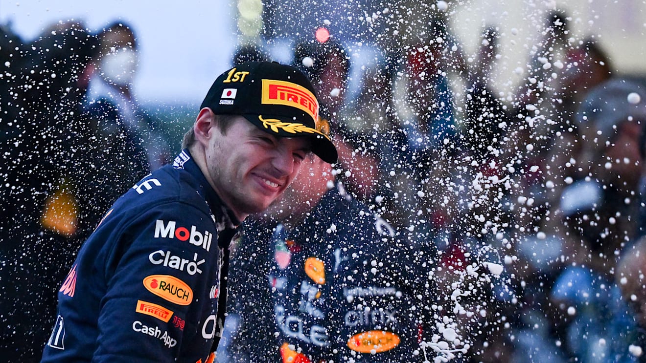 SUZUKA, JAPAN - OCTOBER 09: Race winner and 2022 F1 World Drivers Champion Max Verstappen of the Netherlands and Oracle Red Bull Racing celebrates on the podium during the F1 Grand Prix of Japan at Suzuka International Racing Course on October 09, 2022 in Suzuka, Japan. (Photo by Clive Mason/Getty Images)