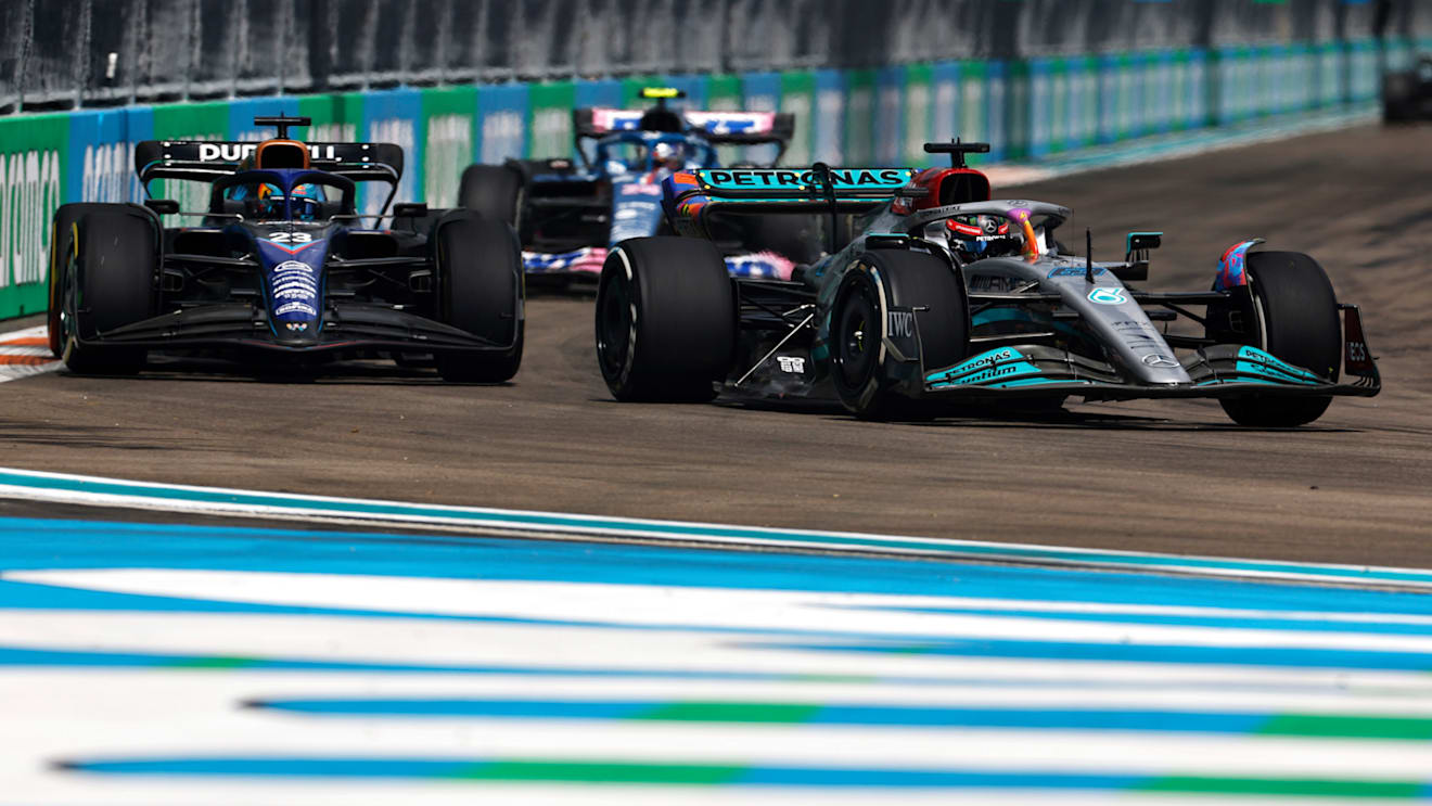 MIAMI, FLORIDA - MAY 08: George Russell of Great Britain driving the (63) Mercedes AMG Petronas F1 Team W13 leads Alexander Albon of Thailand driving the (23) Williams FW44 Mercedes during the F1 Grand Prix of Miami at the Miami International Autodrome on May 08, 2022 in Miami, Florida. (Photo by Chris Graythen/Getty Images)