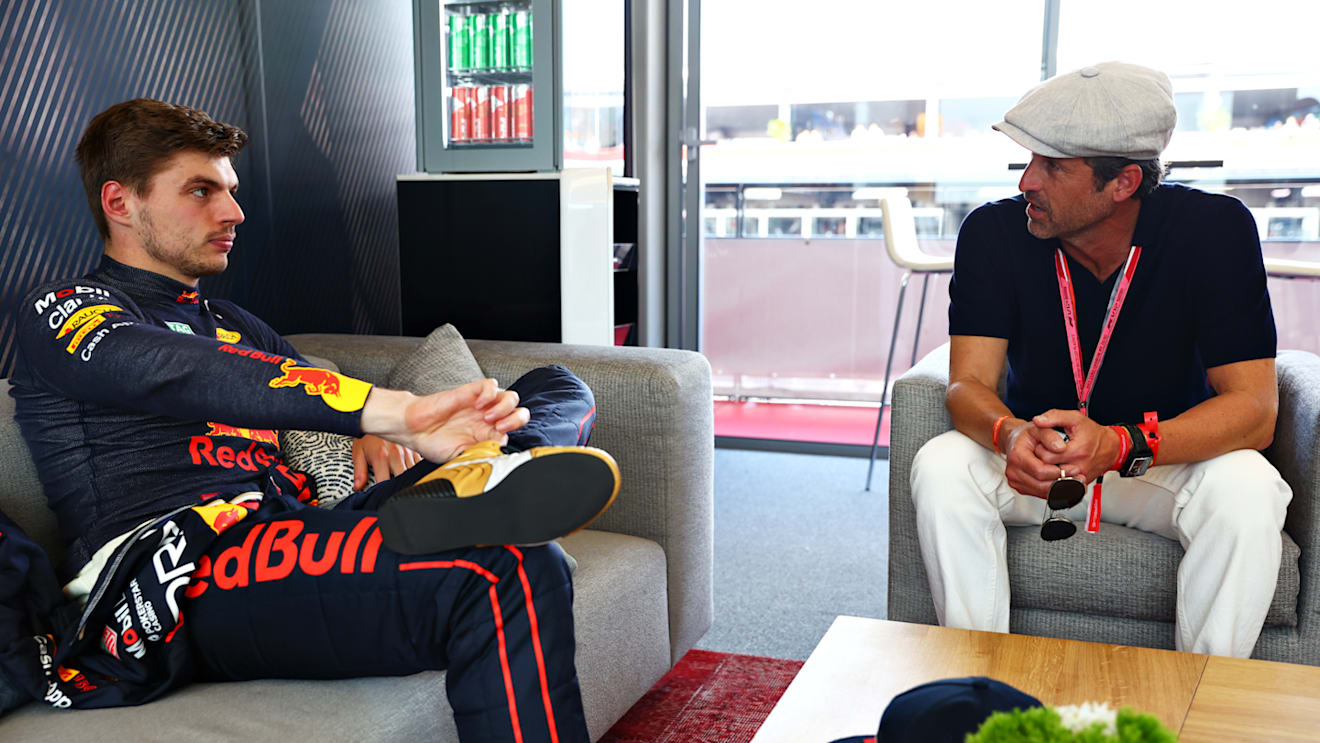 MONTE-CARLO, MONACO - MAY 28: Max Verstappen of the Netherlands and Oracle Red Bull Racing talks with Patrick Dempsey prior to qualifying ahead of the F1 Grand Prix of Monaco at Circuit de Monaco on May 28, 2022 in Monte-Carlo, Monaco. (Photo by Mark Thompson/Getty Images)