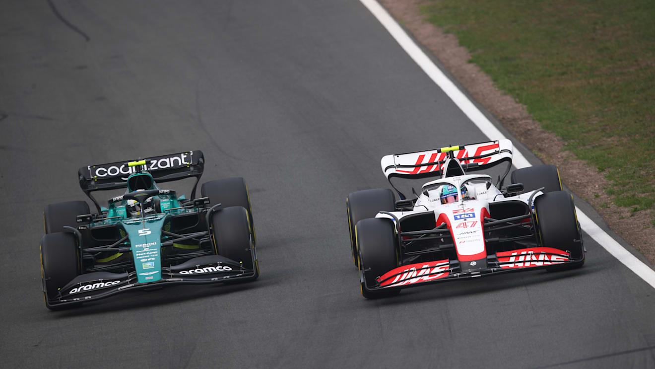 ZANDVOORT, NETHERLANDS - SEPTEMBER 04: Sebastian Vettel of Germany driving the (5) Aston Martin AMR22 Mercedes and Mick Schumacher of Germany driving the (47) Haas F1 VF-22 Ferrari battle for track position during the F1 Grand Prix of The Netherlands at Circuit Zandvoort on September 04, 2022 in Zandvoort, Netherlands. (Photo by Joe Portlock - Formula 1/Formula 1 via Getty Images)