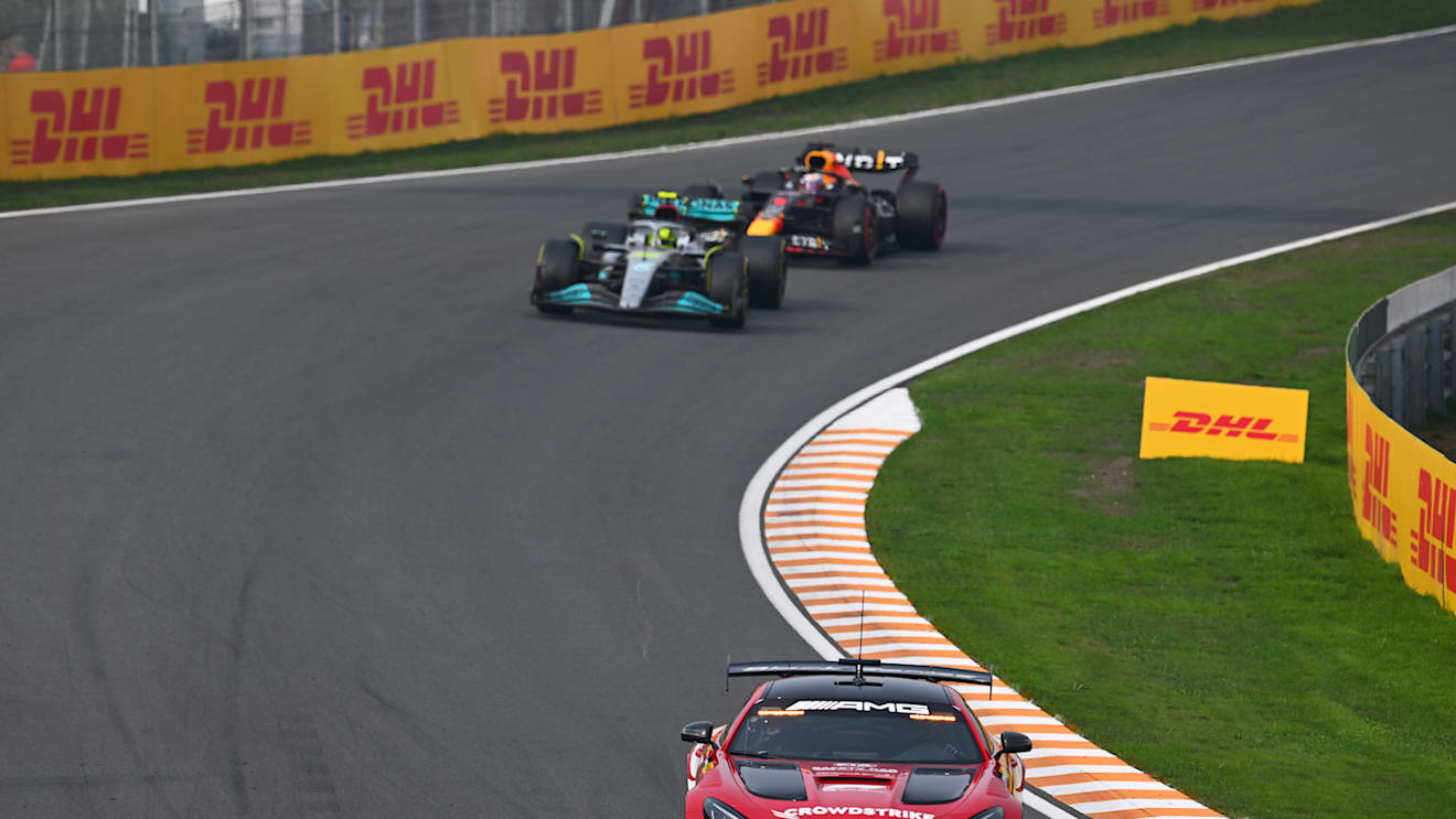 ZANDVOORT, NETHERLANDS - SEPTEMBER 04: The FIA safety car leads Lewis Hamilton of Great Britain driving the (44) Mercedes AMG Petronas F1 Team W13 and Max Verstappen of the Netherlands driving the (1) Oracle Red Bull Racing RB18 during the F1 Grand Prix of The Netherlands at Circuit Zandvoort on September 04, 2022 in Zandvoort, Netherlands. (Photo by Clive Mason/Getty Images)