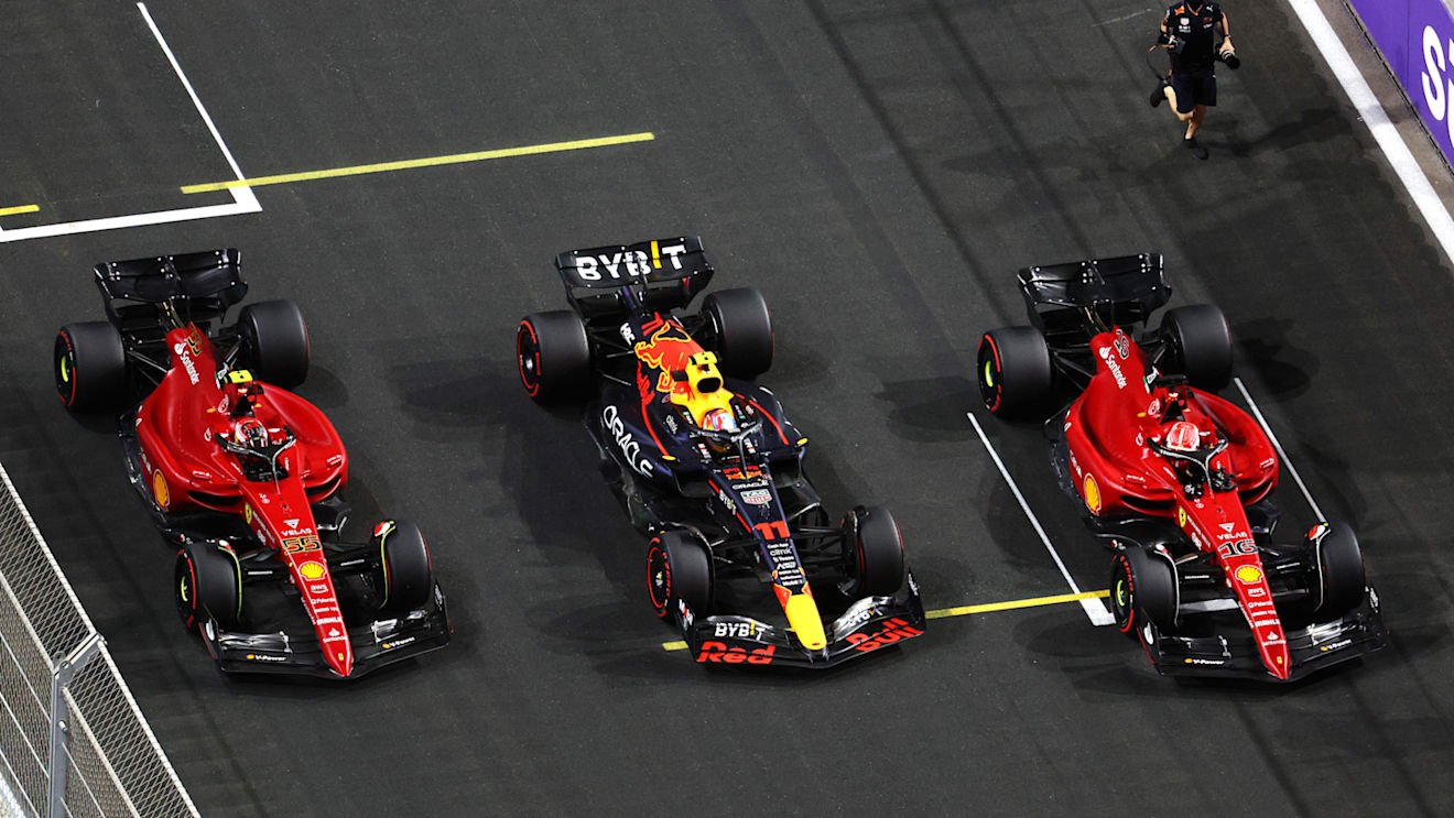 JEDDAH, SAUDI ARABIA - MARCH 26: Pole position qualifier Sergio Perez of Mexico and Oracle Red Bull Racing, Second placed qualifier Charles Leclerc of Monaco and Ferrari and Third placed qualifier Carlos Sainz of Spain and Ferrari stop in parc ferme during qualifying ahead of the F1 Grand Prix of Saudi Arabia at the Jeddah Corniche Circuit on March 26, 2022 in Jeddah, Saudi Arabia. (Photo by Clive Rose - Formula 1/Formula 1 via Getty Images)