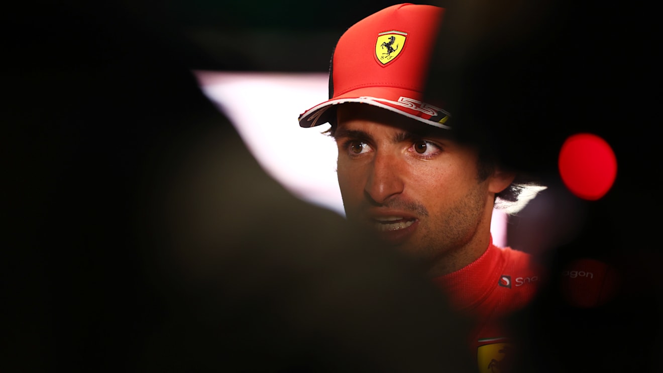 JEDDAH, SAUDI ARABIA - MARCH 26: Third placed qualifier Carlos Sainz of Spain and Ferrari talks to the media in the Paddock after qualifying ahead of the F1 Grand Prix of Saudi Arabia at the Jeddah Corniche Circuit on March 26, 2022 in Jeddah, Saudi Arabia. (Photo by Lars Baron/Getty Images)