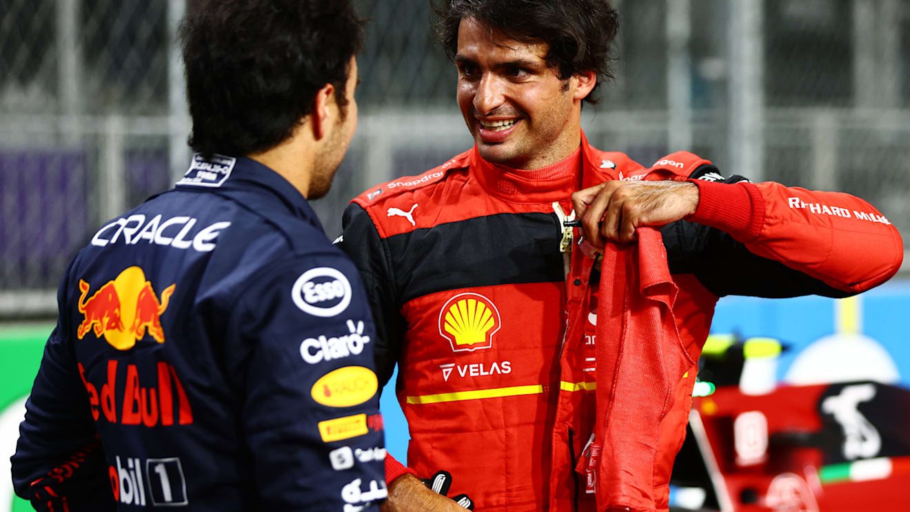 JEDDAH, SAUDI ARABIA - MARCH 26: Third place qualifier Carlos Sainz of Spain and Ferrari talks with Pole position qualifier Sergio Perez of Mexico and Oracle Red Bull Racing in parc ferme during qualifying ahead of the F1 Grand Prix of Saudi Arabia at the Jeddah Corniche Circuit on March 26, 2022 in Jeddah, Saudi Arabia. (Photo by Mark Thompson/Getty Images)