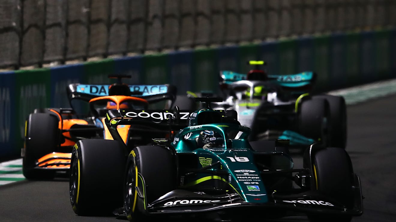 JEDDAH, SAUDI ARABIA - MARCH 27: Lance Stroll of Canada driving the (18) Aston Martin AMR22 Mercedes leads Daniel Ricciardo of Australia driving the (3) McLaren MCL36 Mercedes  during the F1 Grand Prix of Saudi Arabia at the Jeddah Corniche Circuit on March 27, 2022 in Jeddah, Saudi Arabia. (Photo by Joe Portlock - Formula 1/Formula 1 via Getty Images)