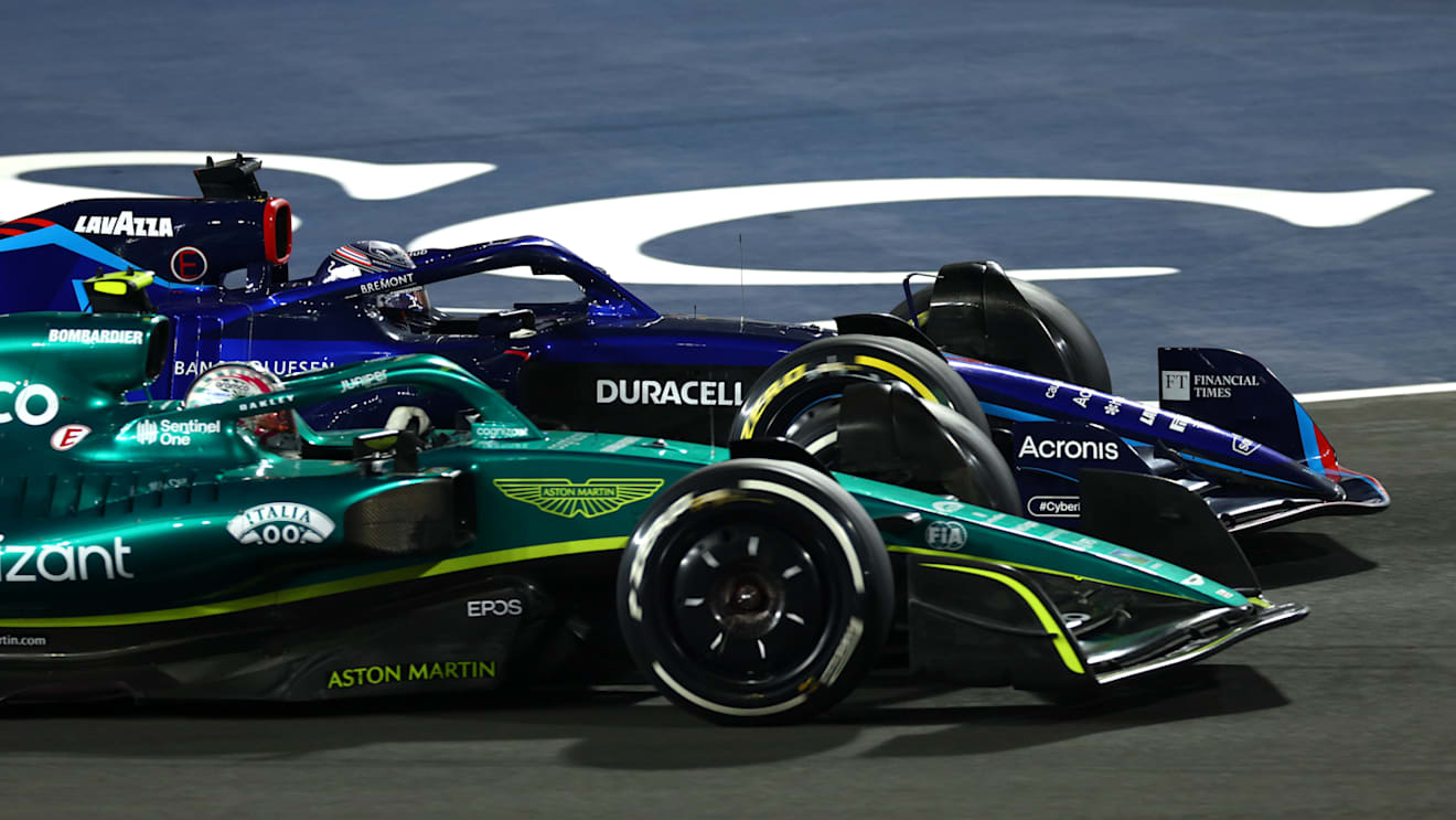 JEDDAH, SAUDI ARABIA - MARCH 27: Nico Hulkenberg of Germany driving the (27) Aston Martin AMR22 Mercedes and Alexander Albon of Thailand driving the (23) Williams FW44 Mercedes battle for track position during the F1 Grand Prix of Saudi Arabia at the Jeddah Corniche Circuit on March 27, 2022 in Jeddah, Saudi Arabia. (Photo by Lars Baron/Getty Images)