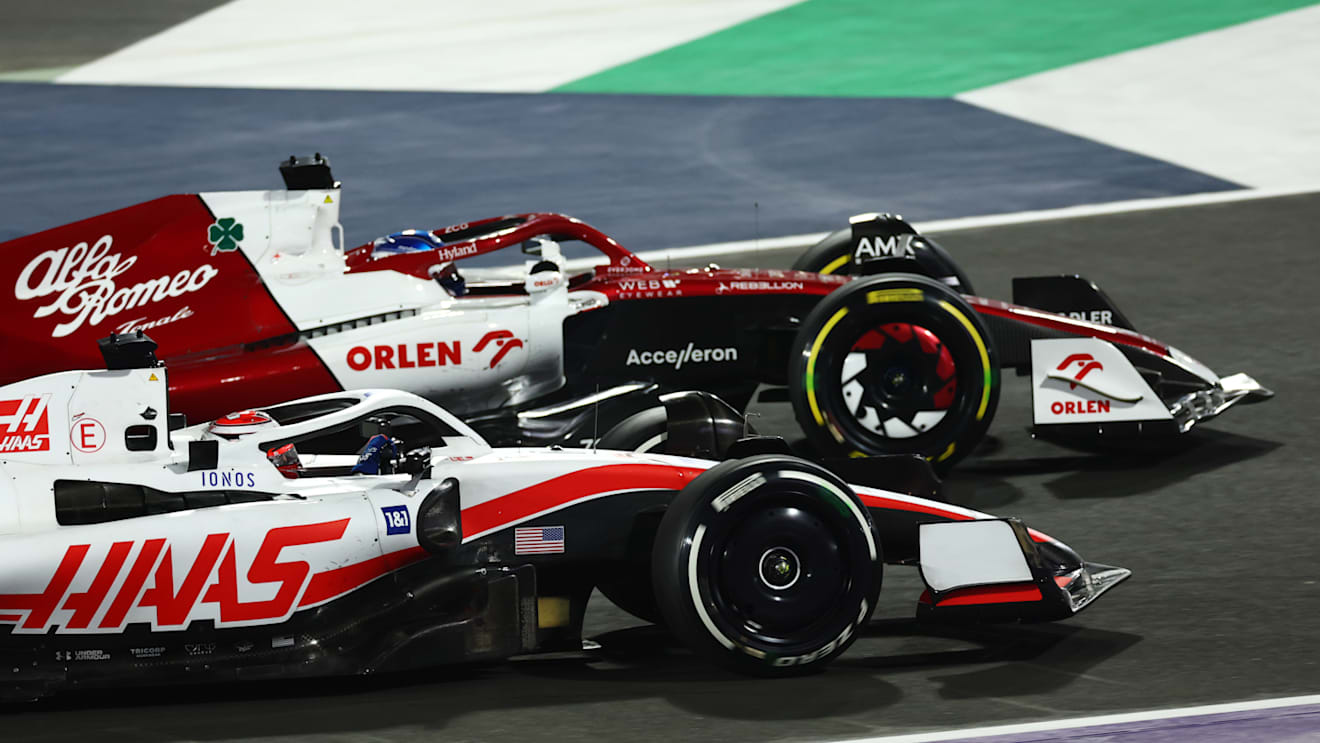 JEDDAH, SAUDI ARABIA - MARCH 27: Valtteri Bottas of Finland driving the (77) Alfa Romeo F1 C42 Ferrari and Kevin Magnussen of Denmark driving the (20) Haas F1 VF-22 Ferrari battle for track position during the F1 Grand Prix of Saudi Arabia at the Jeddah Corniche Circuit on March 27, 2022 in Jeddah, Saudi Arabia. (Photo by Lars Baron/Getty Images)