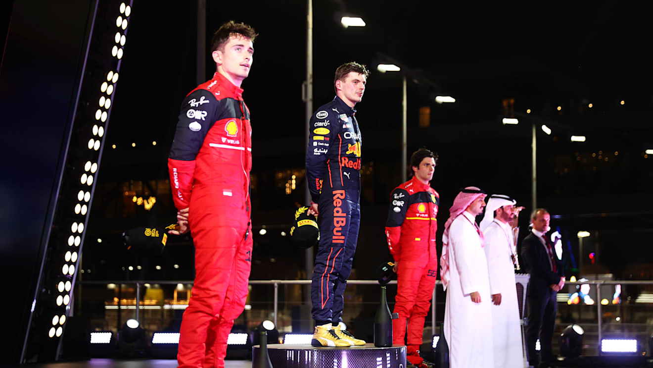 JEDDAH, SAUDI ARABIA - MARCH 27: Race winner Max Verstappen of the Netherlands and Oracle Red Bull Racing, Second placed Charles Leclerc of Monaco and Ferrari and Third placed Carlos Sainz of Spain and Ferrari stand on the podium during the F1 Grand Prix of Saudi Arabia at the Jeddah Corniche Circuit on March 27, 2022 in Jeddah, Saudi Arabia. (Photo by Dan Istitene - Formula 1/Formula 1 via Getty Images)