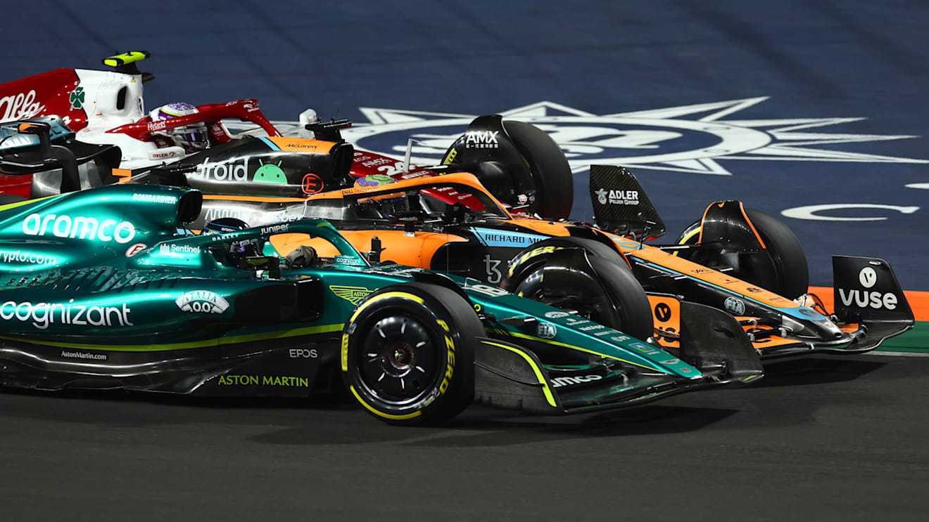 JEDDAH, SAUDI ARABIA - MARCH 27: Lance Stroll of Canada driving the (18) Aston Martin AMR22 Mercedes Daniel Ricciardo of Australia driving the (3) McLaren MCL36 Mercedes and Zhou Guanyu of China driving the (24) Alfa Romeo F1 C42 Ferrari on track during the F1 Grand Prix of Saudi Arabia at the Jeddah Corniche Circuit on March 27, 2022 in Jeddah, Saudi Arabia. (Photo by Lars Baron/Getty Images)