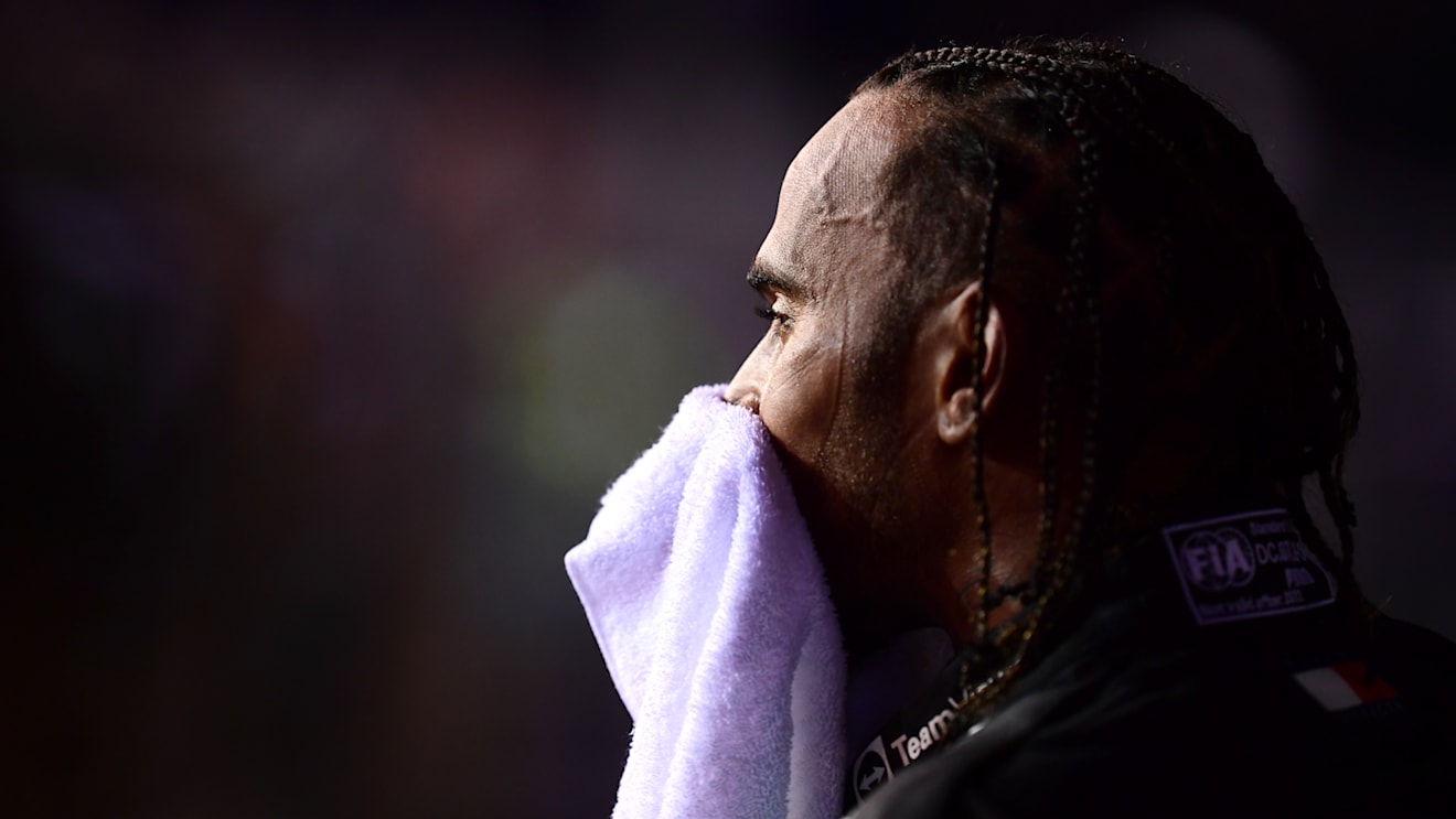 SINGAPORE, SINGAPORE - OCTOBER 01: Third placed qualifier Lewis Hamilton of Great Britain and Mercedes wipes his face with a towel in parc ferme during qualifying ahead of the F1 Grand Prix of Singapore at Marina Bay Street Circuit on October 01, 2022 in Singapore, Singapore. (Photo by Mario Renzi - Formula 1/Formula 1 via Getty Images)