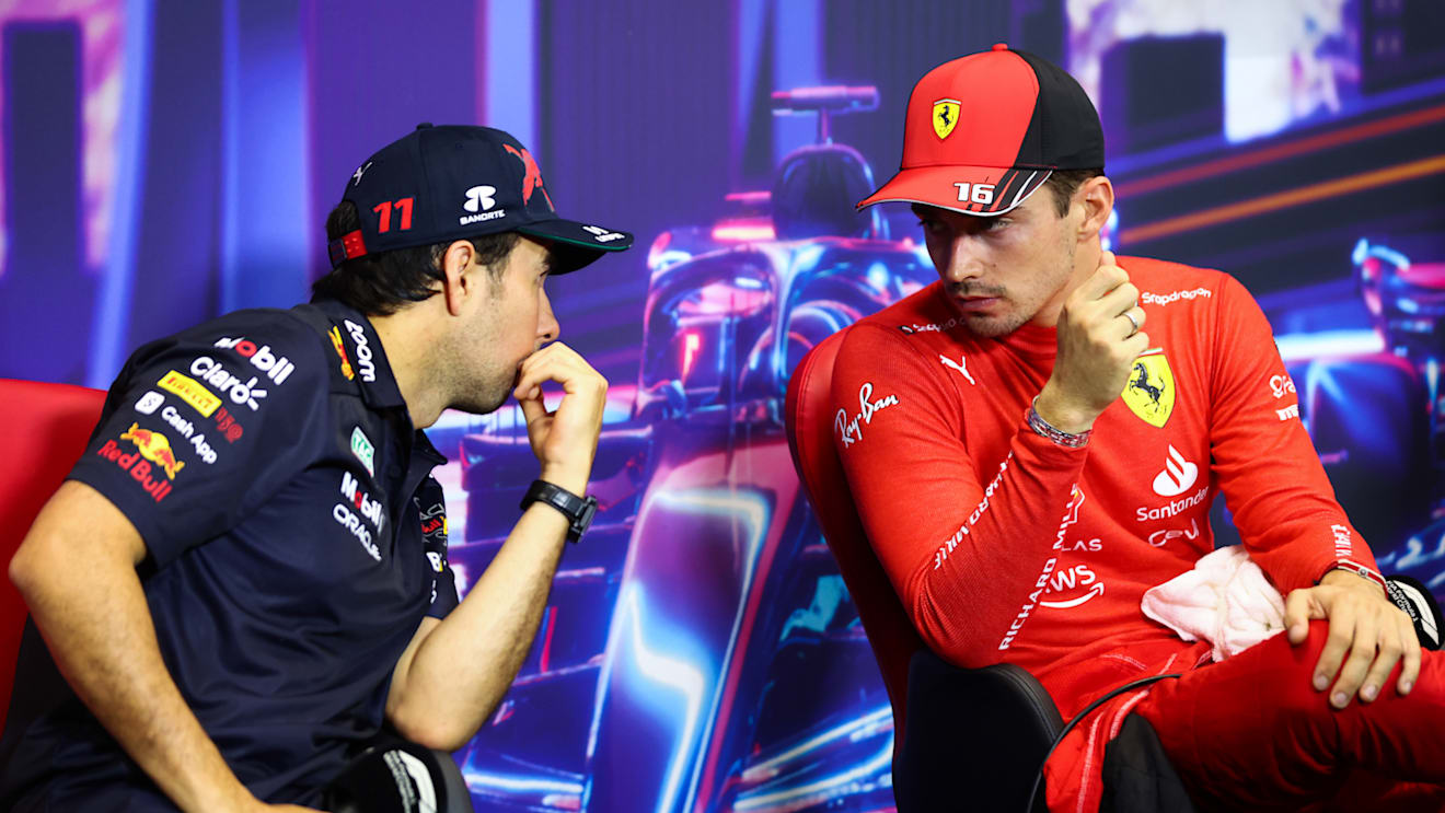 SINGAPORE, SINGAPORE - OCTOBER 01: Pole position qualifier Charles Leclerc of Monaco and Ferrari and Second placed qualifier Sergio Perez of Mexico and Oracle Red Bull Racing talk in the press conference after qualifying ahead of the F1 Grand Prix of Singapore at Marina Bay Street Circuit on October 01, 2022 in Singapore, Singapore. (Photo by Dan Istitene/Getty Images)