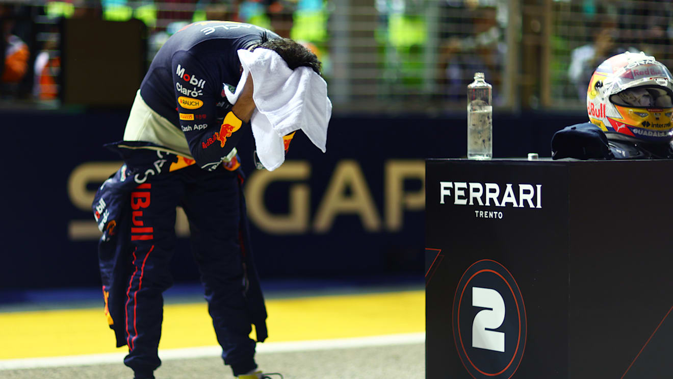 SINGAPORE, SINGAPORE - OCTOBER 01: Second placed qualifier Sergio Perez of Mexico and Oracle Red Bull Racing wipes his head with a towel in parc ferme during qualifying ahead of the F1 Grand Prix of Singapore at Marina Bay Street Circuit on October 01, 2022 in Singapore, Singapore. (Photo by Dan Istitene - Formula 1/Formula 1 via Getty Images)