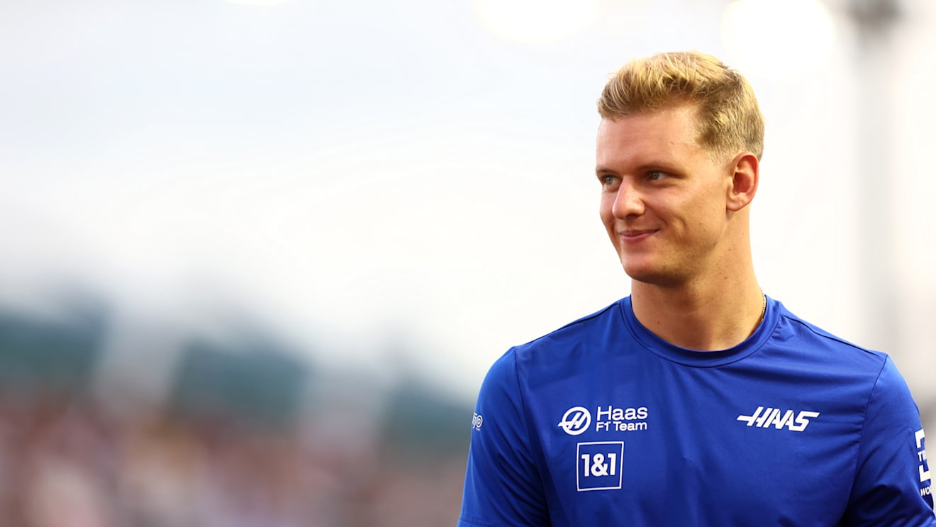 SINGAPORE, SINGAPORE - OCTOBER 02: Mick Schumacher of Germany and Haas F1 looks on from the drivers parade prior to the F1 Grand Prix of Singapore at Marina Bay Street Circuit on October 02, 2022 in Singapore, Singapore. (Photo by Mark Thompson/Getty Images,)