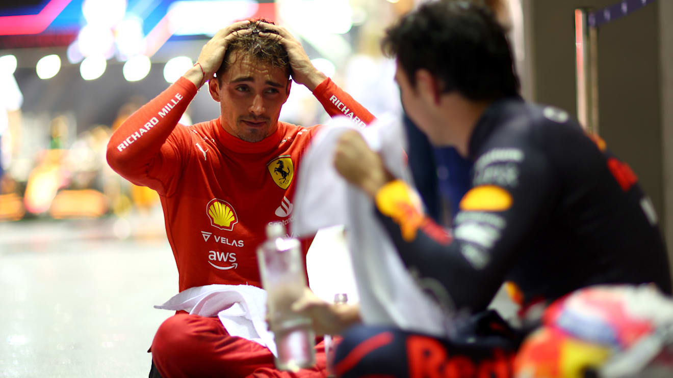 SINGAPORE, SINGAPORE - OCTOBER 02: Race winner Sergio Perez of Mexico and Oracle Red Bull Racing and Second placed Charles Leclerc of Monaco and Ferrari celebrate in parc ferme during the F1 Grand Prix of Singapore at Marina Bay Street Circuit on October 02, 2022 in Singapore, Singapore. (Photo by Dan Istitene - Formula 1/Formula 1 via Getty Images)