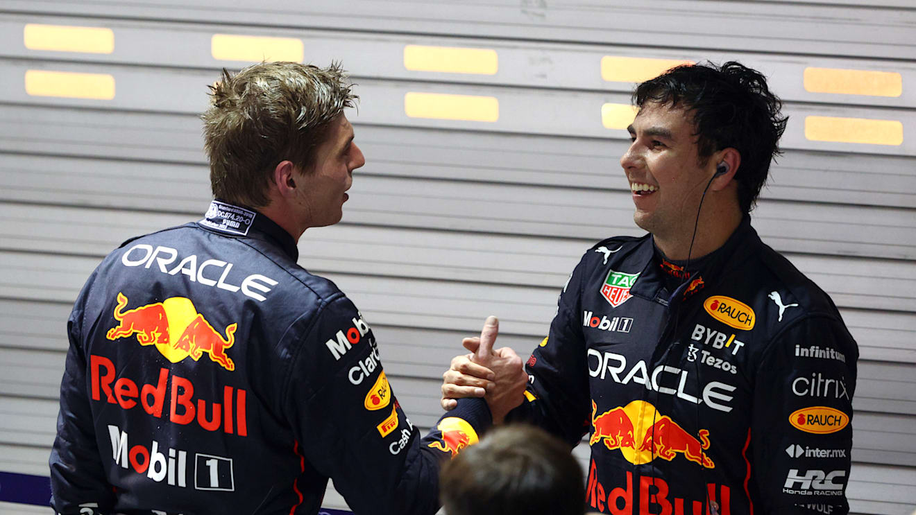 SINGAPORE, SINGAPORE - OCTOBER 02: Race winner Sergio Perez of Mexico and Oracle Red Bull Racing is congratulated by seventh placed Max Verstappen of the Netherlands and Oracle Red Bull Racing in parc ferme during the F1 Grand Prix of Singapore at Marina Bay Street Circuit on October 02, 2022 in Singapore, Singapore. (Photo by Clive Rose/Getty Images,)