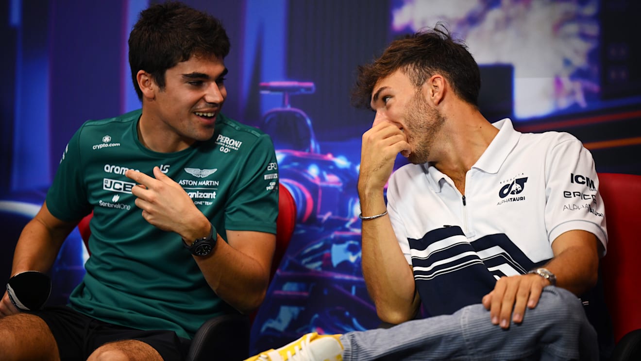 SINGAPORE, SINGAPORE - SEPTEMBER 29: Pierre Gasly of France and Scuderia AlphaTauri and Lance Stroll of Canada and Aston Martin F1 Team talk in the Drivers Press Conference during previews ahead of the F1 Grand Prix of Singapore at Marina Bay Street Circuit on September 29, 2022 in Singapore, Singapore. (Photo by Clive Mason/Getty Images,)
