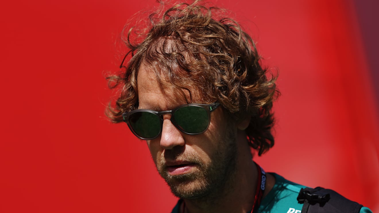 BARCELONA, SPAIN - MAY 21: Sebastian Vettel of Germany and Aston Martin F1 Team walks in the Paddock prior to practice ahead of the F1 Grand Prix of Spain at Circuit de Barcelona-Catalunya on May 21, 2022 in Barcelona, Spain. (Photo by Bryn Lennon - Formula 1/Formula 1 via Getty Images)