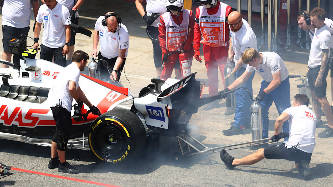 BARCELONA, SPAIN - MAY 21: The Haas F1 team put out a fire on the rear of the car of Mick Schumacher of Germany and Haas F1 in the Pitlane during practice ahead of the F1 Grand Prix of Spain at Circuit de Barcelona-Catalunya on May 21, 2022 in Barcelona, Spain. (Photo by Dan Istitene - Formula 1/Formula 1 via Getty Images)
