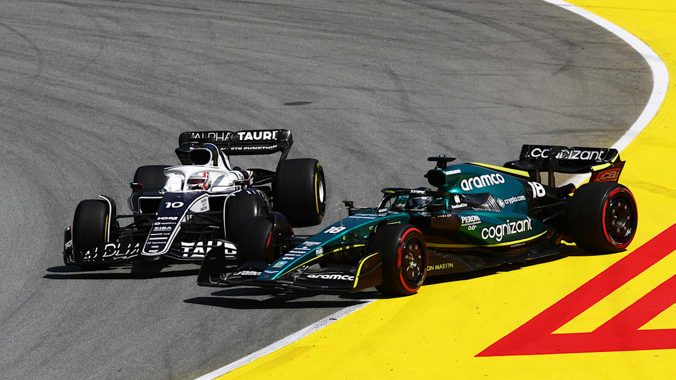 BARCELONA, SPAIN - MAY 22: Pierre Gasly of France driving the (10) Scuderia AlphaTauri AT03 and Lance Stroll of Canada driving the (18) Aston Martin AMR22 Mercedes battle for track position during the F1 Grand Prix of Spain at Circuit de Barcelona-Catalunya on May 22, 2022 in Barcelona, Spain. (Photo by Lars Baron/Getty Images)