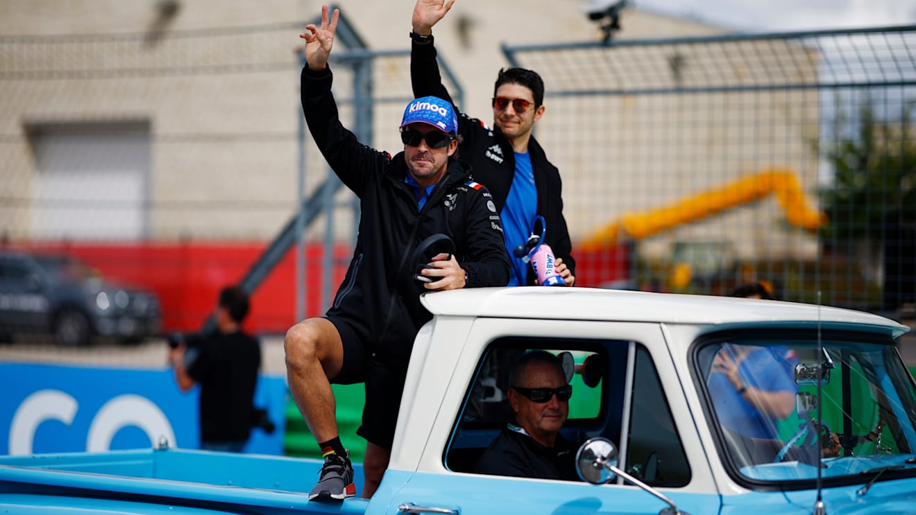 AUSTIN, TEXAS - OCTOBER 23: Fernando Alonso of Spain and Alpine F1 and Esteban Ocon of France and Alpine F1 wave to the crowd on the drivers parade prior to the F1 Grand Prix of USA at Circuit of The Americas on October 23, 2022 in Austin, Texas. (Photo by Chris Graythen/Getty Images)