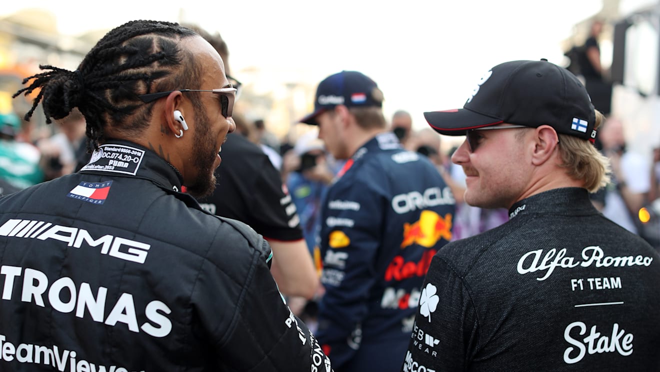 BAHRAIN, BAHRAIN - MARCH 05: Lewis Hamilton of Great Britain and Mercedes talks with Valtteri Bottas of Finland and Alfa Romeo F1 prior to the F1 Grand Prix of Bahrain at Bahrain International Circuit on March 05, 2023 in Bahrain, Bahrain. (Photo by Peter Fox/Getty Images)