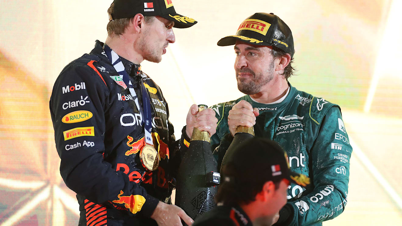 BAHRAIN, BAHRAIN - MARCH 05: Race winner Max Verstappen of the Netherlands and Oracle Red Bull Racing and Third placed Fernando Alonso of Spain and Aston Martin F1 Team celebrate on the podium during the F1 Grand Prix of Bahrain at Bahrain International Circuit on March 05, 2023 in Bahrain, Bahrain. (Photo by Peter Fox/Getty Images)