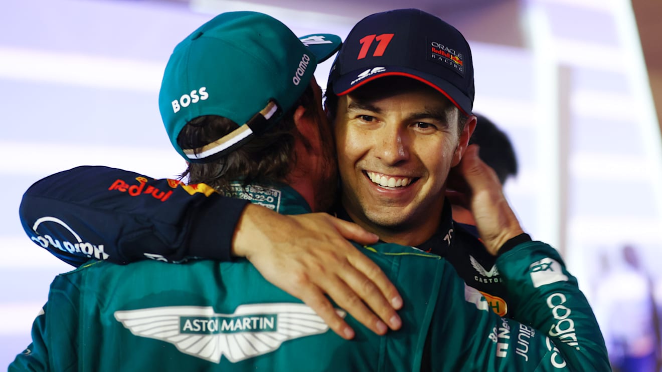 BAHRAIN, BAHRAIN - MARCH 05: Second placed Sergio Perez of Mexico and Oracle Red Bull Racing congratulates Third placed Fernando Alonso of Spain and Aston Martin F1 Team in parc ferme during the F1 Grand Prix of Bahrain at Bahrain International Circuit on March 05, 2023 in Bahrain, Bahrain. (Photo by Bryn Lennon - Formula 1/Formula 1 via Getty Images)