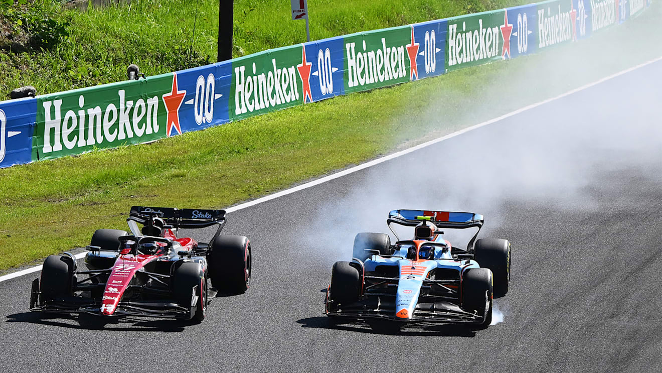 SUZUKA, JAPAN - SEPTEMBER 24: Logan Sargeant of United States driving the (2) Williams FW45 Mercedes locks a wheel under braking as he battles for track position with Valtteri Bottas of Finland driving the (77) Alfa Romeo F1 C43 Ferrari during the F1 Grand Prix of Japan at Suzuka International Racing Course on September 24, 2023 in Suzuka, Japan. (Photo by Clive Mason/Getty Images)