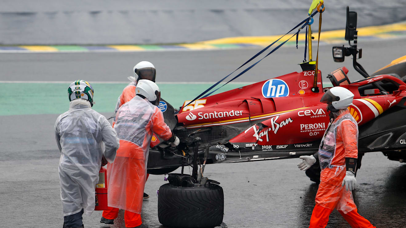 The car of Ferrari's Spanish driver Carlos Sainz is removed from the track after an accident during the qualifying session for the Formula One Sao Paulo Grand Prix, at the Jose Carlos Pace racetrack, aka Interlagos, in Sao Paulo, Brazil, on November 3, 2024. (Photo by Miguel Schincariol / AFP) (Photo by MIGUEL SCHINCARIOL/AFP via Getty Images)